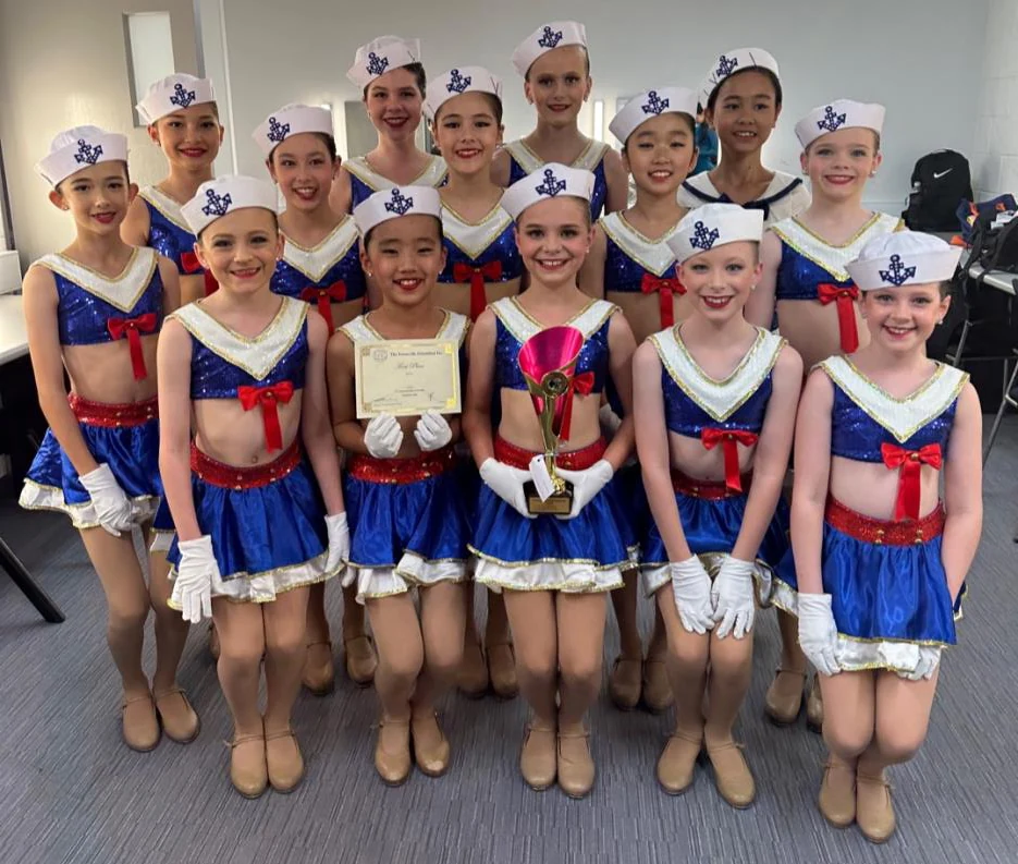 JMDS tap troupe in sailor costumes and tap shoes with their trophy
