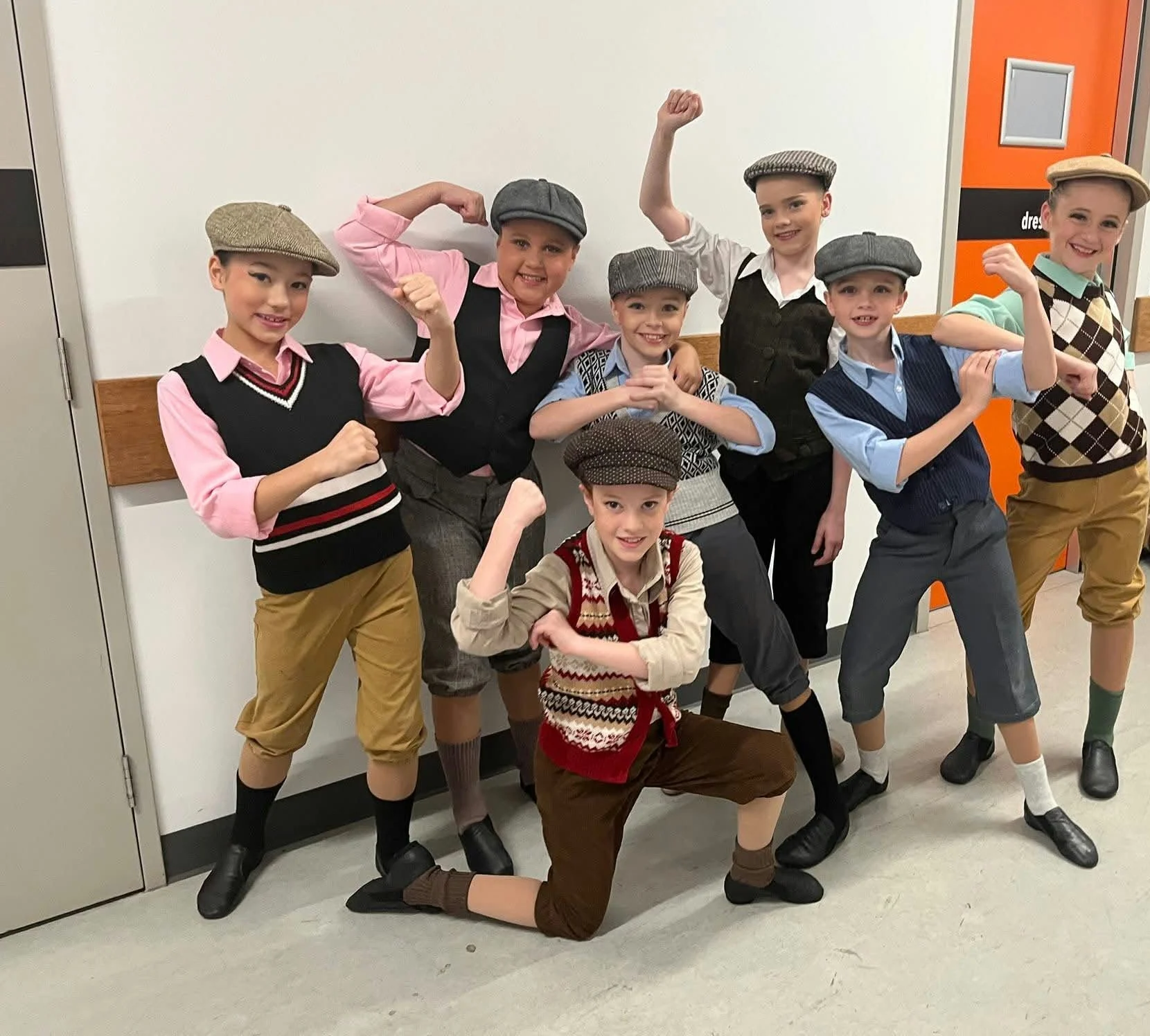 JMDS dancers in newsboy caps backstage